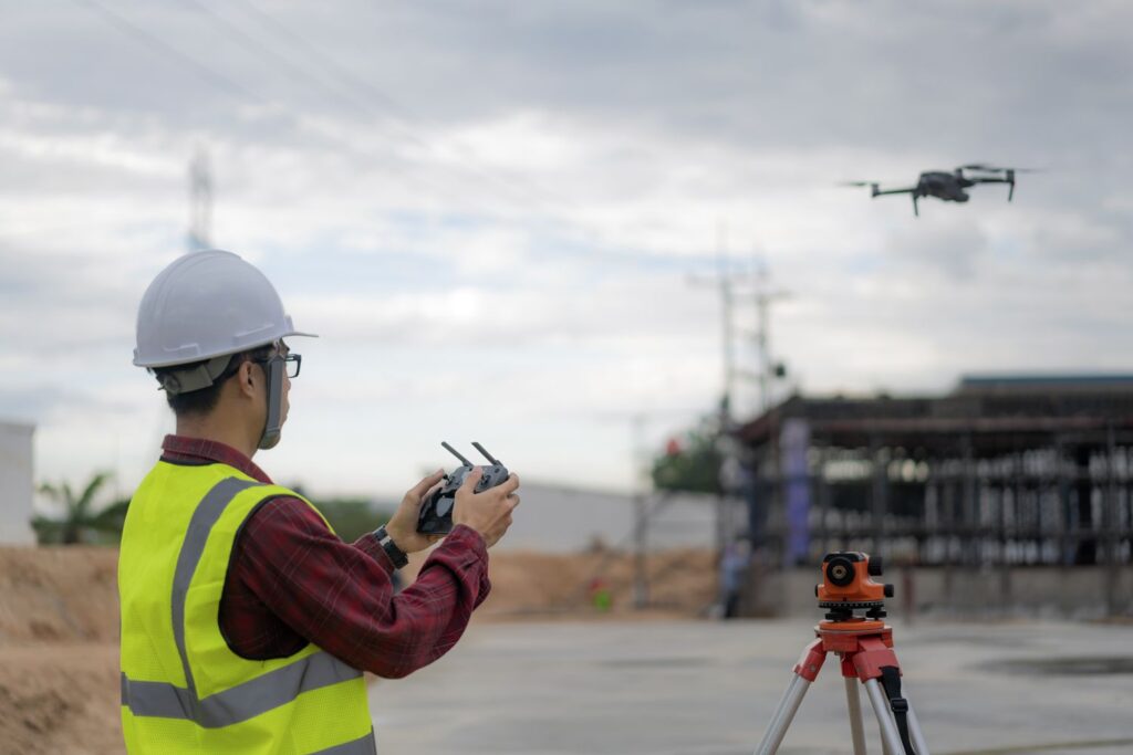 Asian Construction Worker Piloting Drone At Building Site Video Surveillance Or Industrial Inspection 1134482179 0eaae7a705fa4813ba24af65729368e6 1024x683